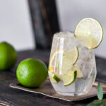 Cold cocktail with lime, lemon, tonic, vodka and ice