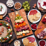 Christmas appetizer table scene against a dark wood background