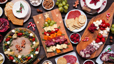 Christmas appetizer table scene against a dark wood background