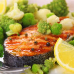fried salmon with broccoli as a side dish
