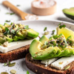 healthy toasts with avocado cheese and whole wheat rye bread on a plate