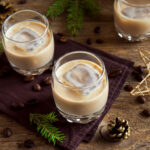baileys cream coffee liqueur with ice with ornaments over rustic wooden background