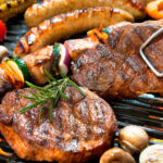 assorted delicious grilled bbq with vegetables over the coals on barbecue