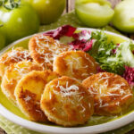 fried green tomato with fresh salad close-up on a plate and ingredients on a table