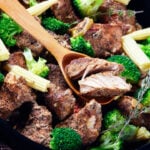 Leftover steak kebabs with vegetables on a black baking dish