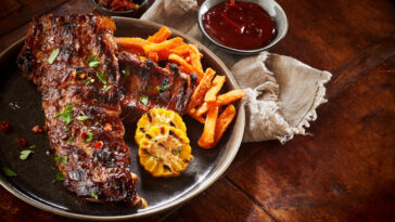 ribs served on a plate with side dishes