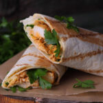 Tasty wraps with grilled chicken meat and fresh parsley