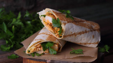 Tasty wraps with grilled chicken meat and fresh parsley