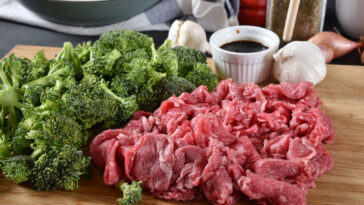 shaved beef with broccoli on a chopping board
