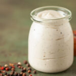 Alabama white BBQ sauce in bowl and ingredient for dip .