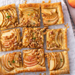 Apple tart, an apple desserts with puff pastry topped with sliced apples, walnuts and brown sugar caramel sliced into squares