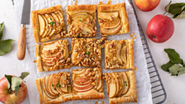 Apple tart, an apple desserts with puff pastry topped with sliced apples, walnuts and brown sugar caramel sliced into squares