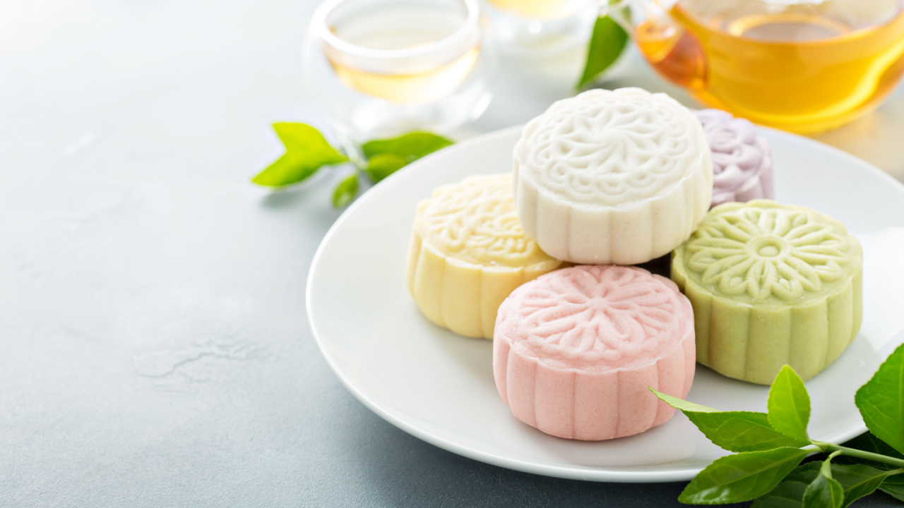 Snow skin sweet and savory traditional Chinese mooncakes with variety of fillings and green tea