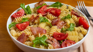 blt pasta salad consisting of rotini, bacon, lettuce and tomatoes.