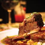 Close up of braised beef short rib on dinner table. Selective focus.