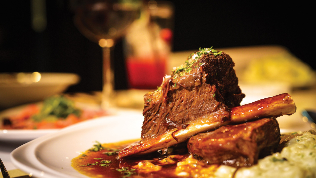 Close up of braised beef short rib on dinner table. Selective focus.