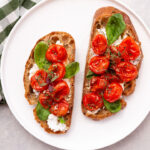 bruschetta with tomatoes on a white plate
