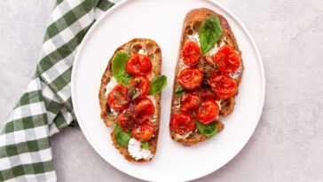 bruschetta with tomatoes on a white plate