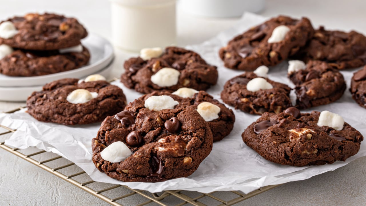 Chocolate chip and marshmallow dark chocolate cookies served with milk.