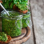 Homemade cilantro pesto in jars.