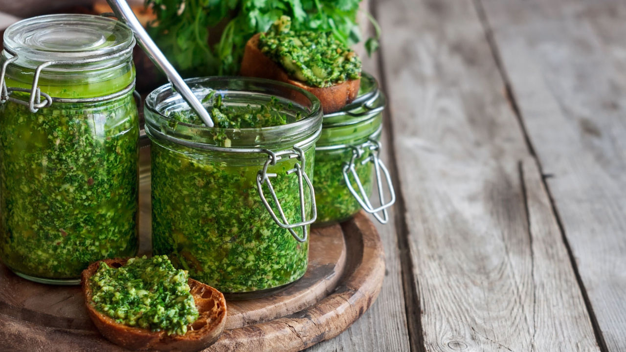 Homemade cilantro pesto in jars.