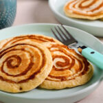 Cinnamon roll pancakes served on plate