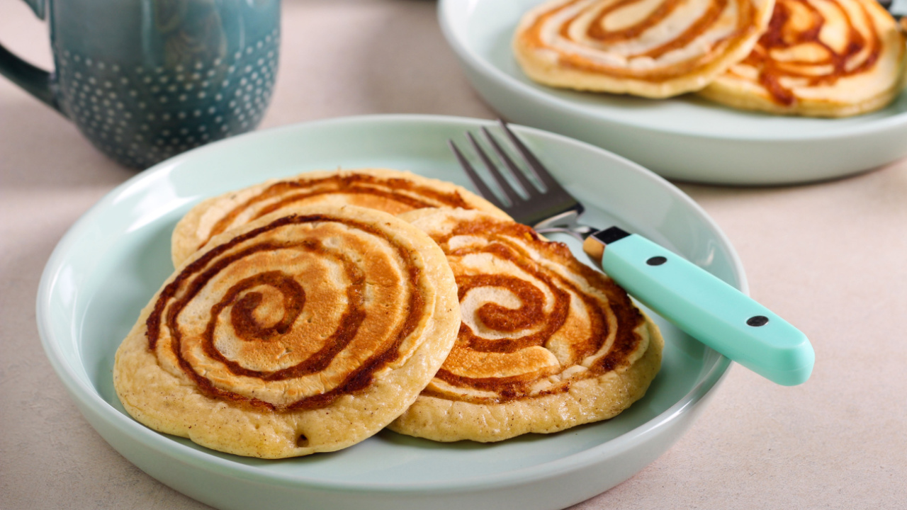 Cinnamon roll pancakes served on plate