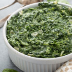 Creamed spinach with garlic in a white bowl