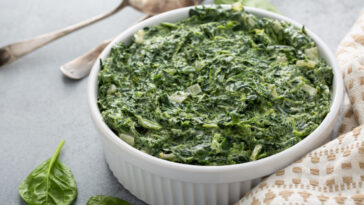 Creamed spinach with garlic in a white bowl