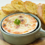 baked pizza dip with Garlic bread.