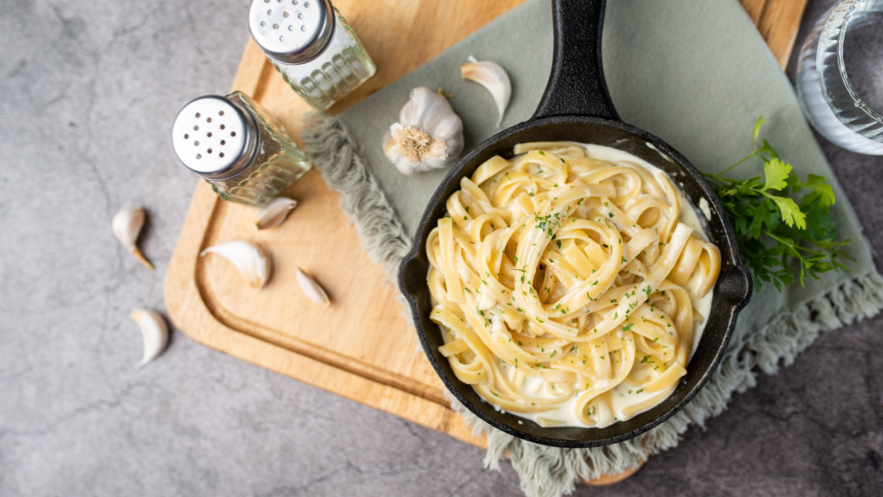 Alfredo pasta dinner with creamy white sauce and herbs