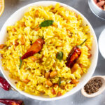 Yellow Rice, Turmeric Rice with Lemon, Ginger and Fenugreek in a white bowl, Indian Food.