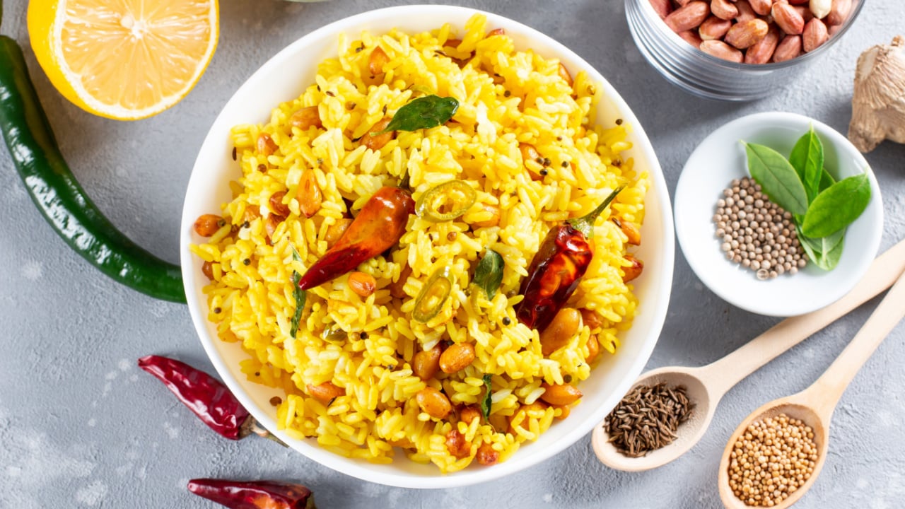 Yellow Rice, Turmeric Rice with Lemon, Ginger and Fenugreek in a white bowl, Indian Food.