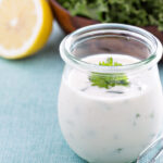 Homemade ranch dressing in a small jar with herbs