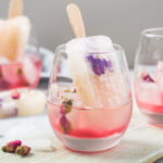 Cocktail glasses of pink rose champagne, or lemonade with dry rose buds and ice cream.