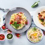 Plates of pastas with different kinds of sauces, top view. Italian food concept.