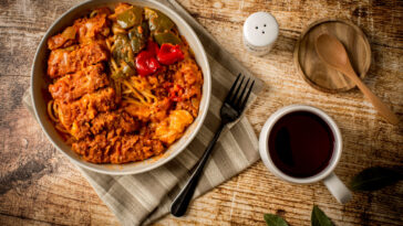 Hong Kong style Baked Pork Chop with Spaghetti with Blackcurrant juice on the table.