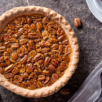 A delicious home made pecan pie on a stone counter top.