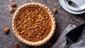 A delicious home made pecan pie on a stone counter top.