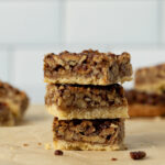 Tasty pecan bars stacked on parchment paper