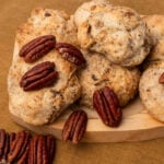 crispy pecan sandies cookies on a brown paper towel. cookies with buttery, and nutty goodness.