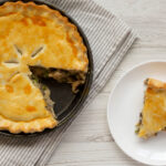 A Piece of Chicken Pot Pie on a white wooden surface