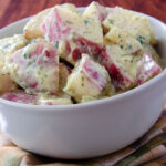 Delicious creamy potato salad dressed in mayo infused with dijon mustard.