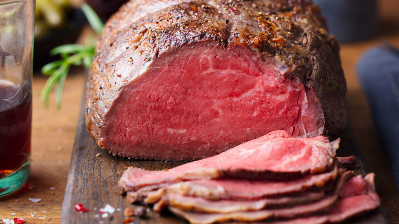 Roast beef on cutting board.