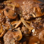 Salisbury steak with mushroom gravy in a cast iron skillet