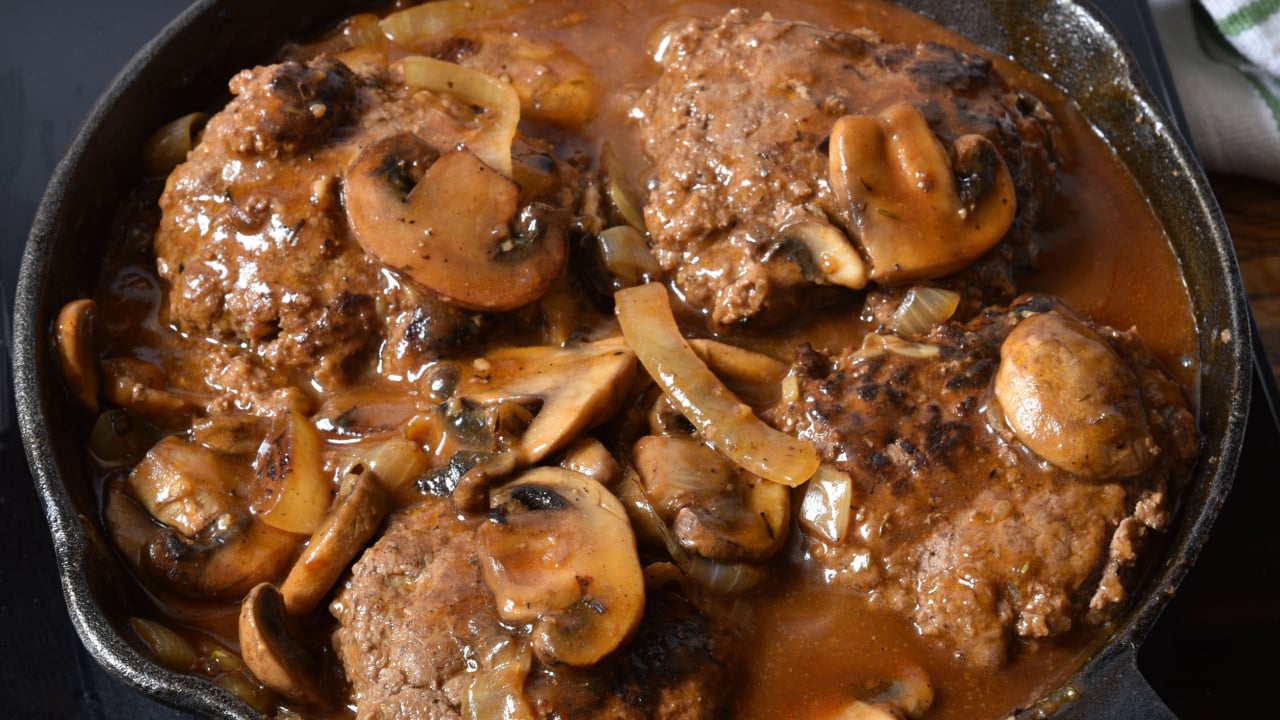 Salisbury steak with mushroom gravy in a cast iron skillet