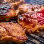 BBQ chicken thigh on the flaming grill