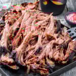 Traditional barbecue wagyu pulled beef offered with Carolina BBQ sauce and onion rings.
