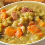 A bowl of split pea soup with ham