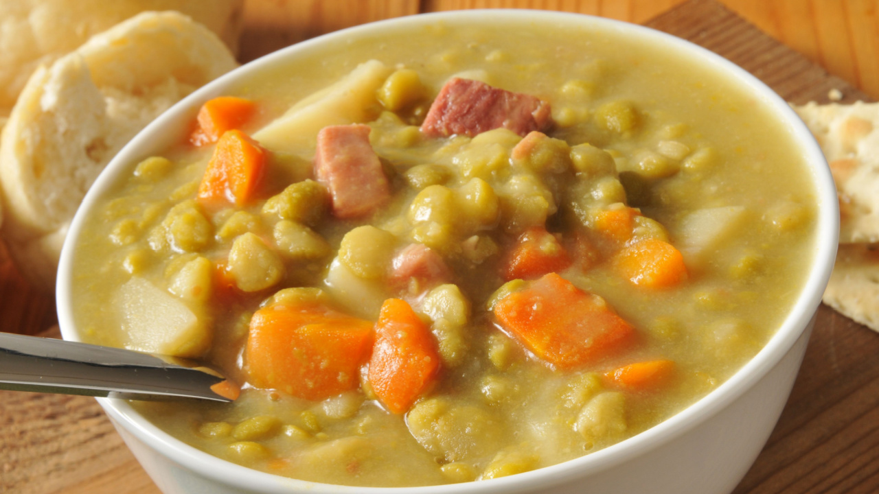 A bowl of split pea soup with ham